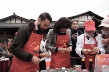 千人体验沙县小吃技艺，“老外”捶肉馅包饺子感叹温馨又美好  